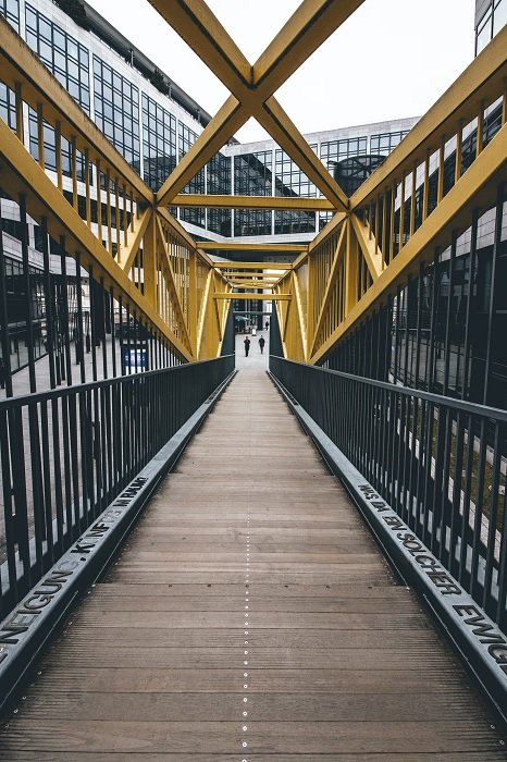 Iron-cast bridge with yellow bars as an example of leading lines in geometric photography