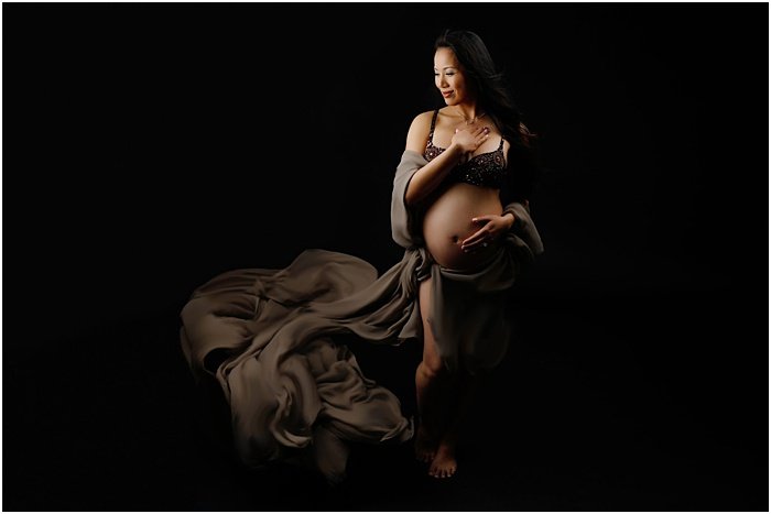 Photo of a pregnant woman in front of a black background