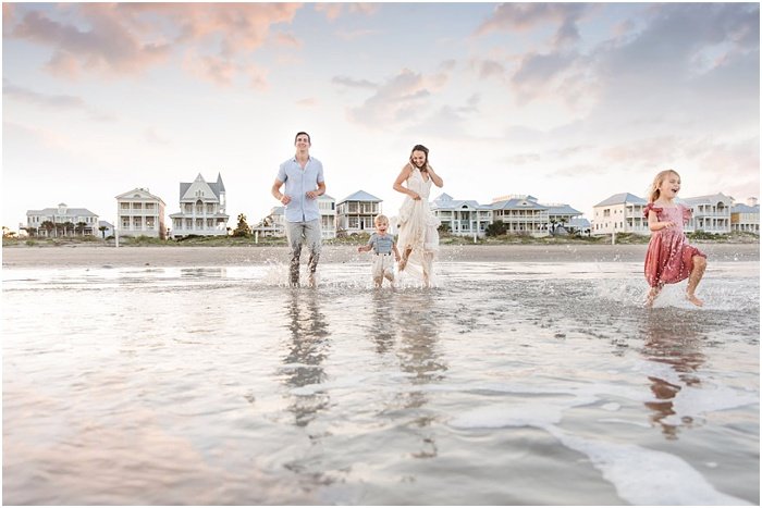 Photo of a family running on the beach by Chubby Cheek Photography