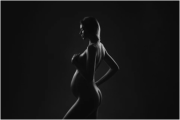 Black and white photo of a pregnant woman by Donatella Nicolini