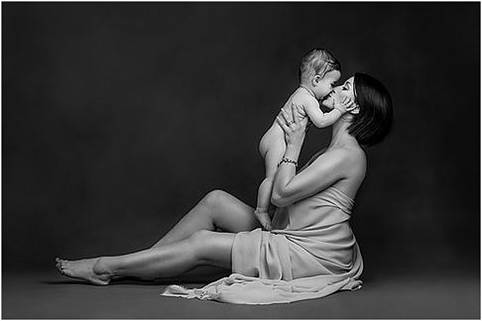 Black and white photo of a mother and her baby by Donatella Nicolini