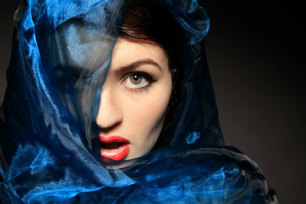 A woman with her face partially covered by a veil as an example of framing photography shots