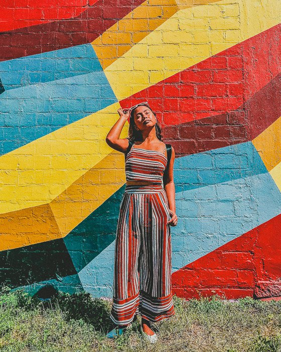 Colourful photo of a girl with different angles on a brick wall in the background