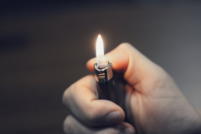 Close-up photo of a hand holding a lighter
