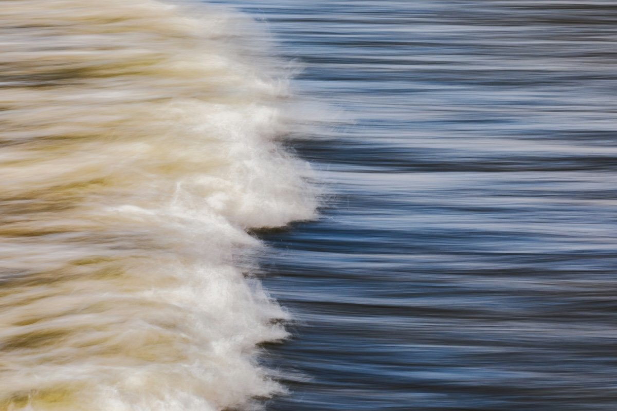 Blurry ocean waves created by handheld panning for intentional camera movement