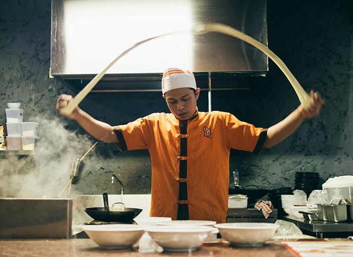 Motion blur photo of an Asian cook