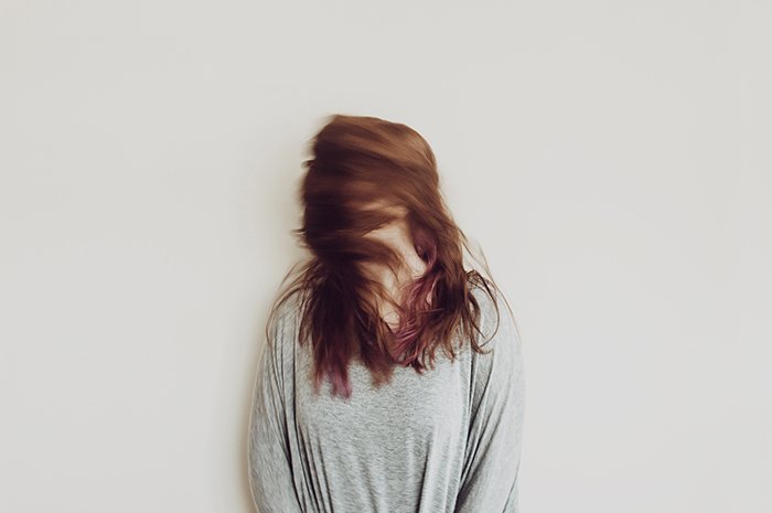 Motion blur photo of a woman shaking her hair