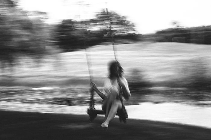 Motion blur photo of a woman on a swing