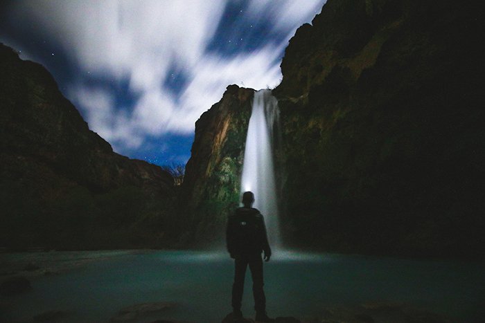 Motion blur photo of a waterfall at nighttime