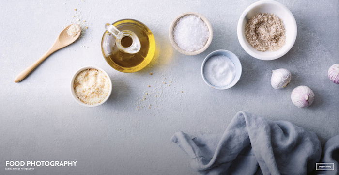 An advertisement for a photography course featuring various cooking ingredients on a table.