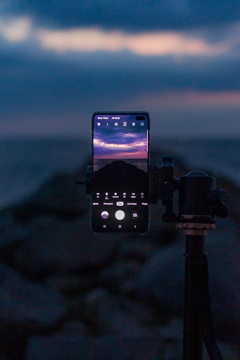 a smartphone on a tripod capturing a glorious sunset