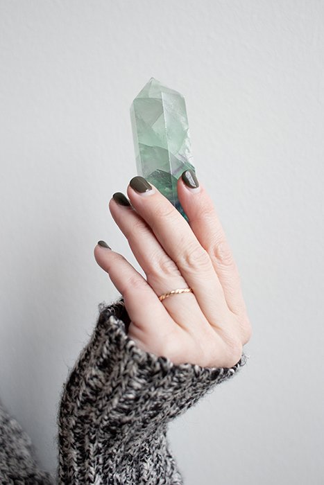 cool nail photography of a female model with painted nails holding a precious gem