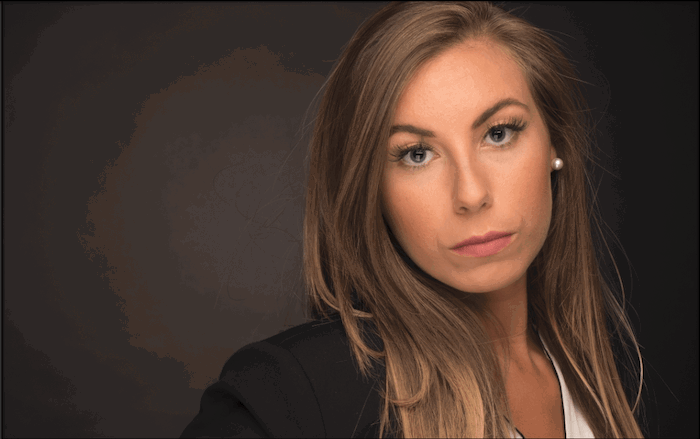 Portrait photo of a woman with dark background