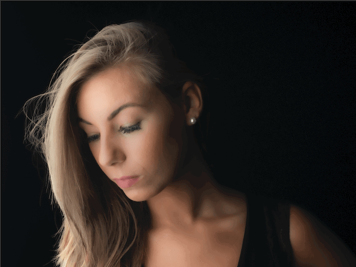 Portrait photo of a woman with dark background