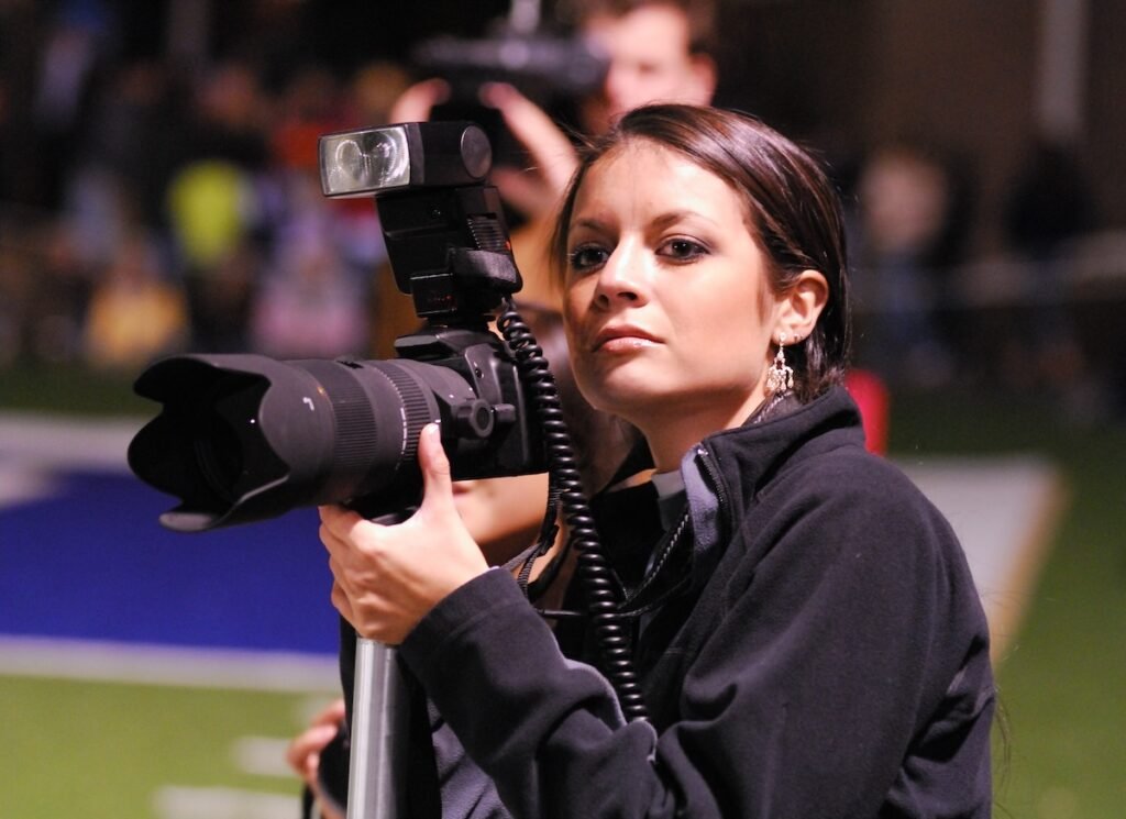 Photographer with sports photography equipment on the sidelines