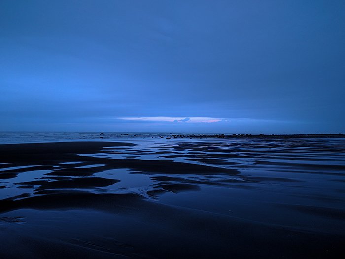 Photo of a waterscape at blue hour in soft blue light