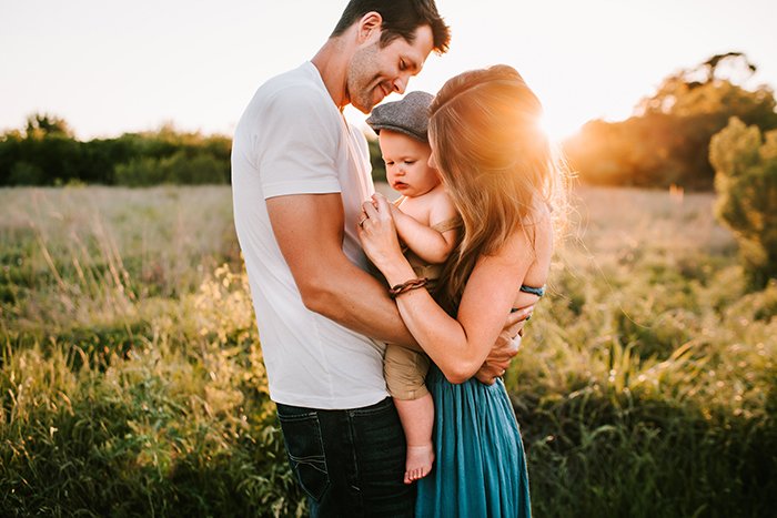 Photo of a family on a field at sunset in golden light