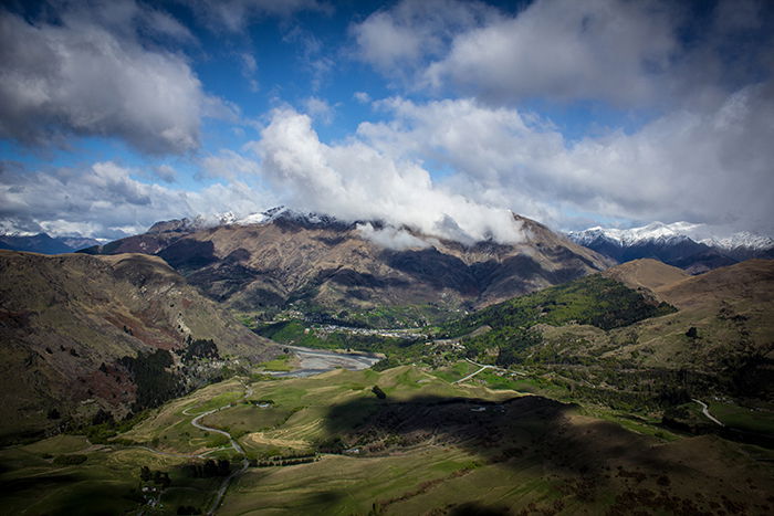 Landscape photo of a valley with clouds in spotlight