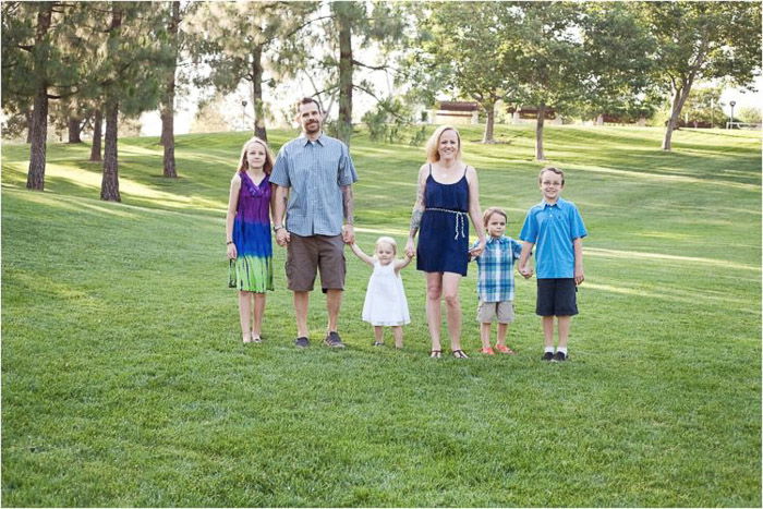 lifestyle portrait of a family with young kids demonstrating good ways to photograph unruly children