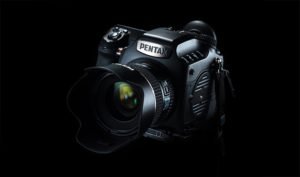 A Pentax camera on a black background