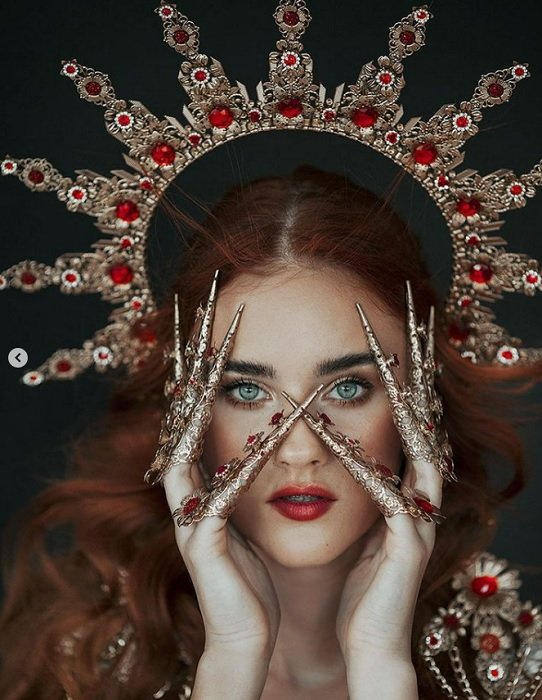 Portrait of a woman with a jewelled halo and jewelled finger pointers