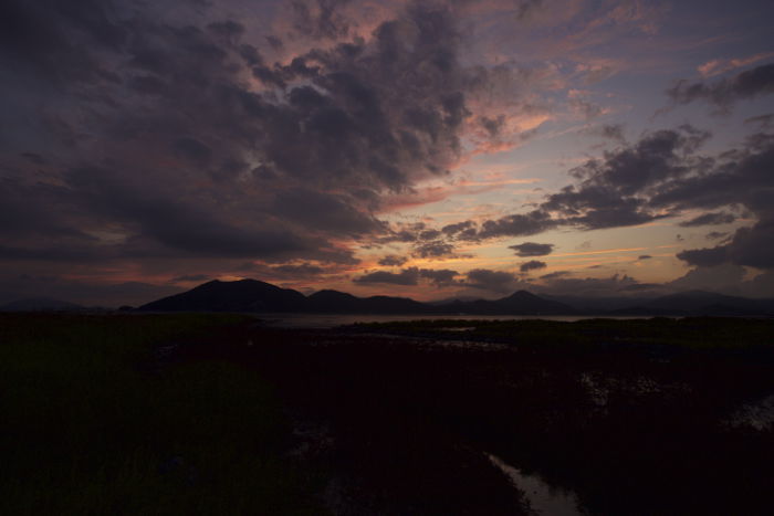 A dramatic sunset image with an underexposed foreground 