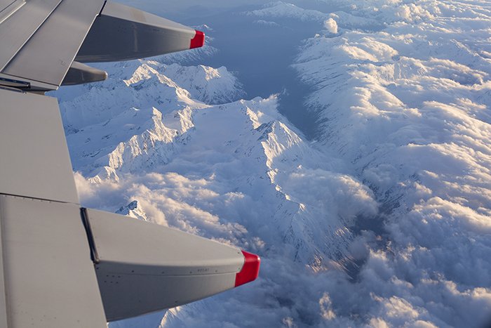 Photo of mountains with snowy tops shot from an airplane