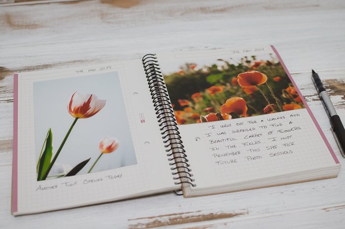 notebook, photos and stationary for making a photo journal