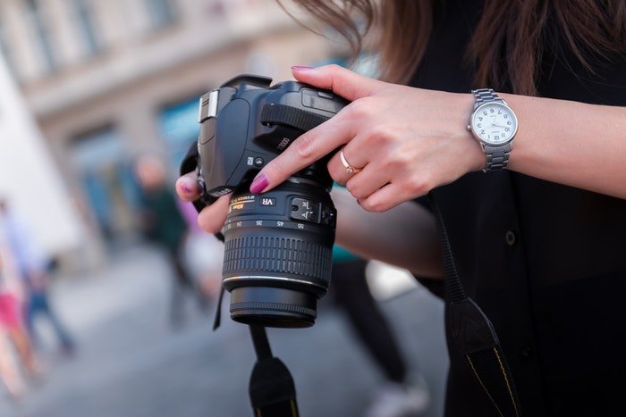 Photo of a woman holding a dslr camera