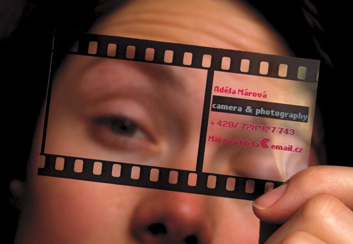 a person holding a photography business card to her face 
