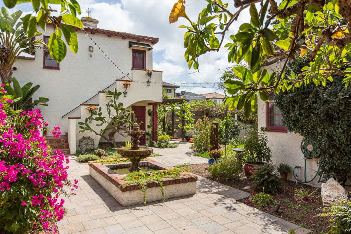 the exterior and garden of a beautiful house