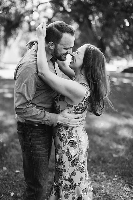 black and white portrait of a couple hugging and rubbing noses