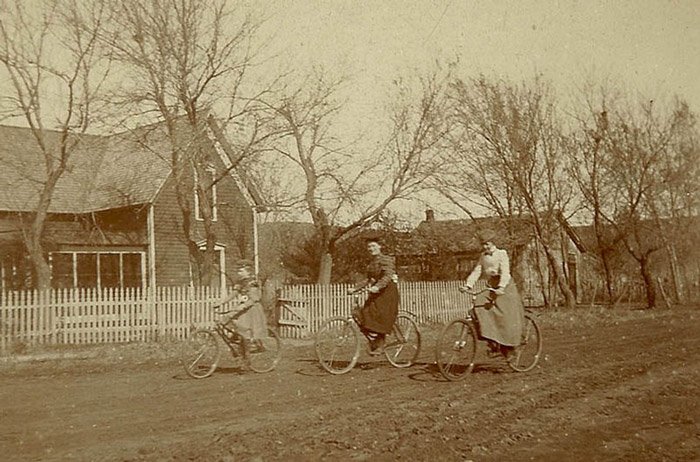 Old photo of a family cycling in the countryside