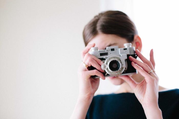 Woman taking a picture with a Kodak digital camera