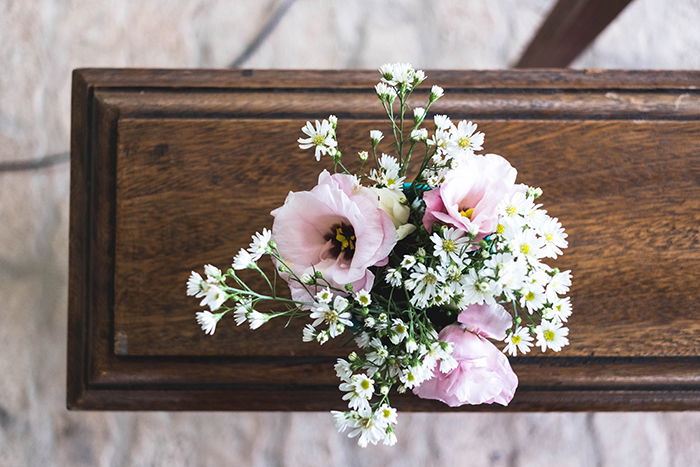 an overhead view of flowers on a closed coffin