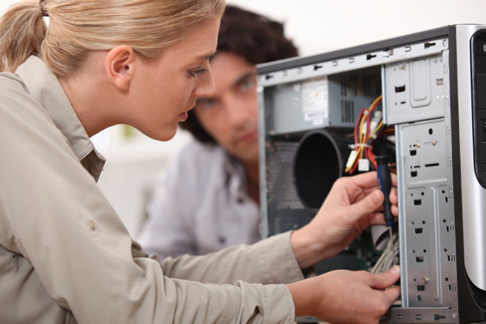 Photo of a woman checking the inside of a computer