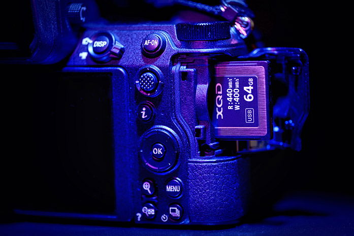 An XQD card being placed into a camera 