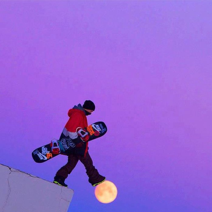 Photo of a snowboarder looking like he is stepping on the moon