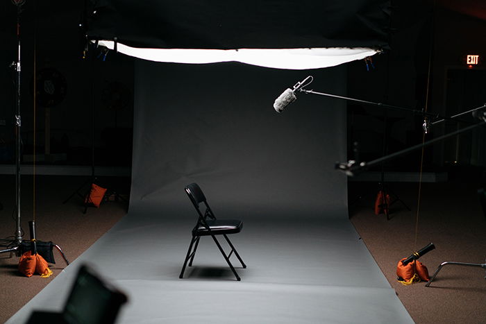 Photo of a photography studio setup with a chair in the middle