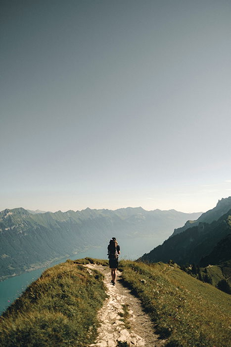 A person standing on the edge of a mountain 