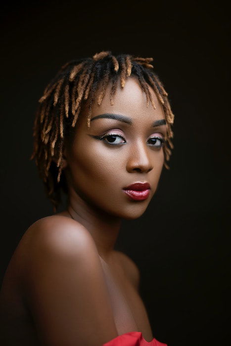 A well lit portrait photograph of a woman 