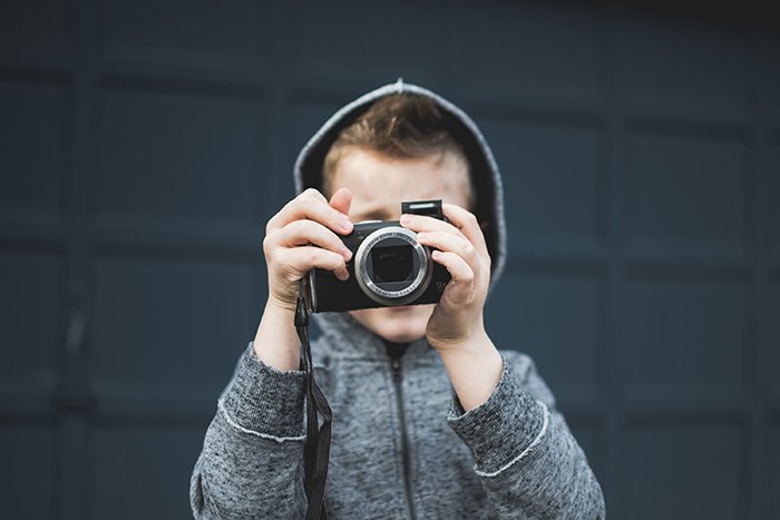 Photo of a little boy with a camera