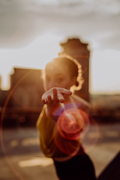 A photo of a girl holding out her hand, only the hand is in focus