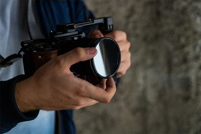 photo of someone holding a camera with an nd filter