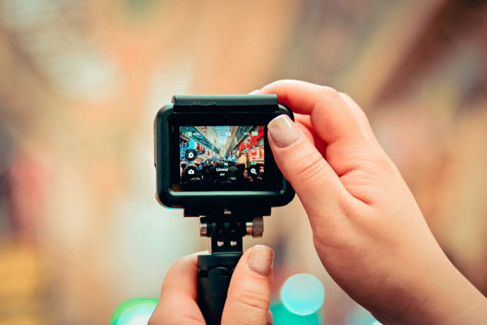 An image of hands holding a GoPro to take a picture 