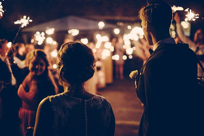 a candid photo of an outdoor wedding celebration at night 