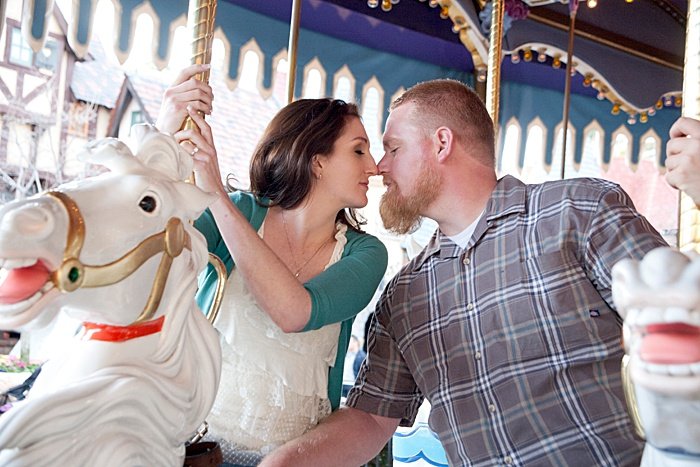 a romantic portrait of a couple kissing on a carousel