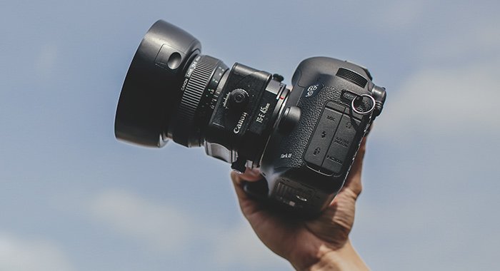 Photo of a hand holding a Canon camera