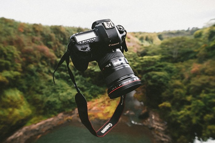 A Canon camera suspended in the air 
