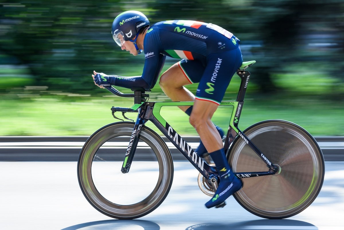 Panning shot of a professional cyclist speeding by as an example of cycling photography